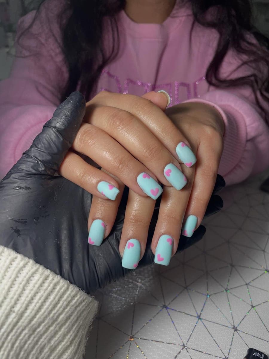 Pastel mint nails with pink heart accents